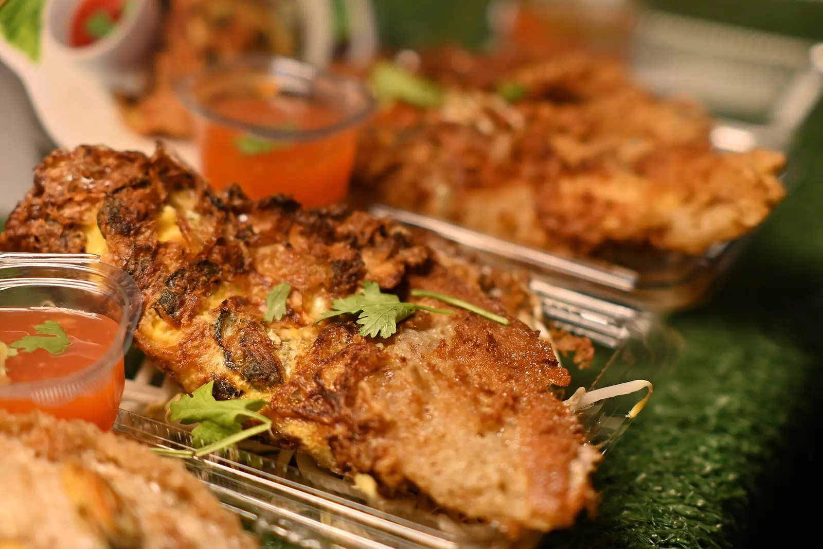 Grilled seafood skewers with cilantro and a chili dip, the sort of plate Pattaya's seafood restaurants are known for