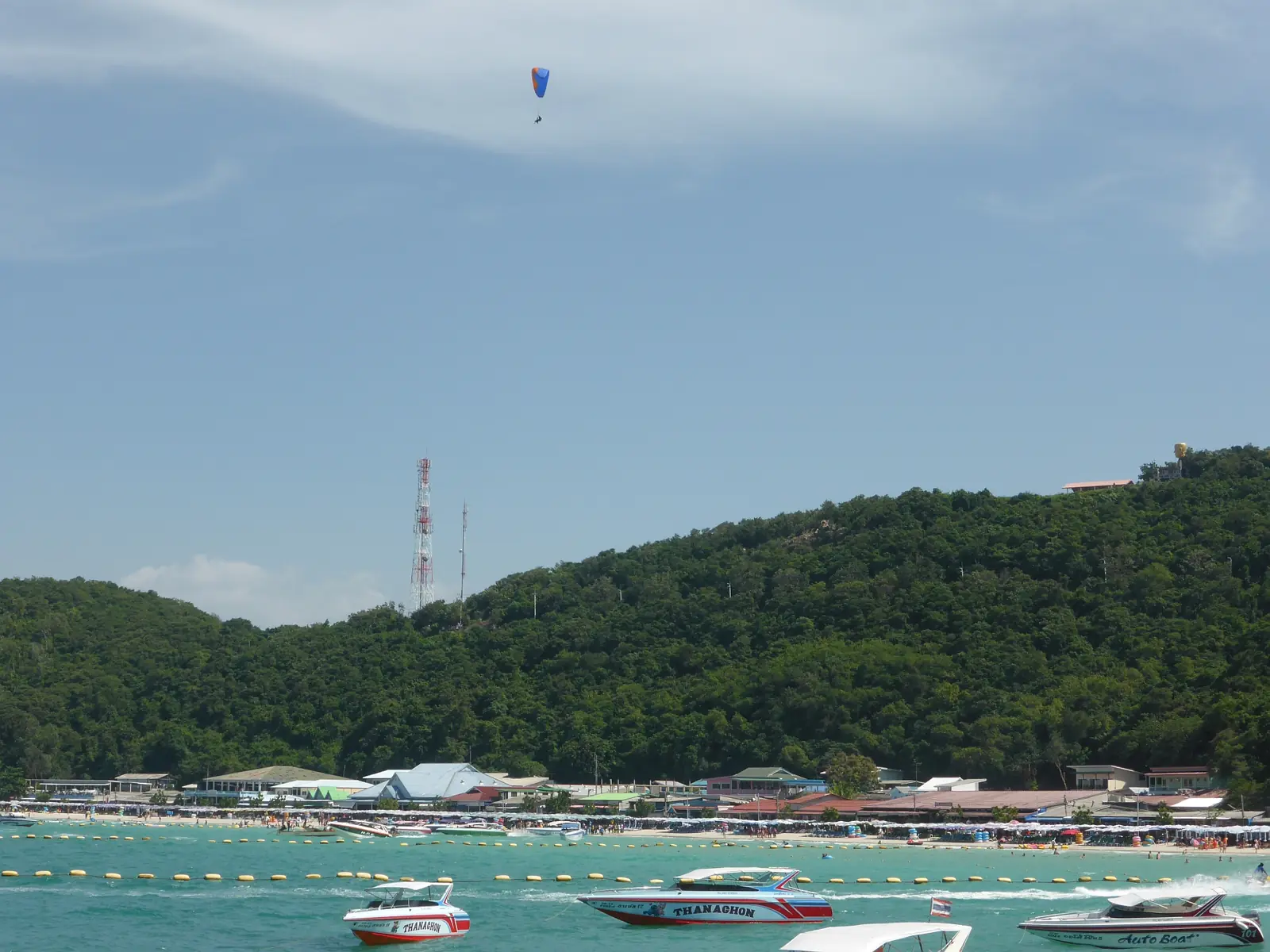 A speedboat moving across green water off Koh Larn