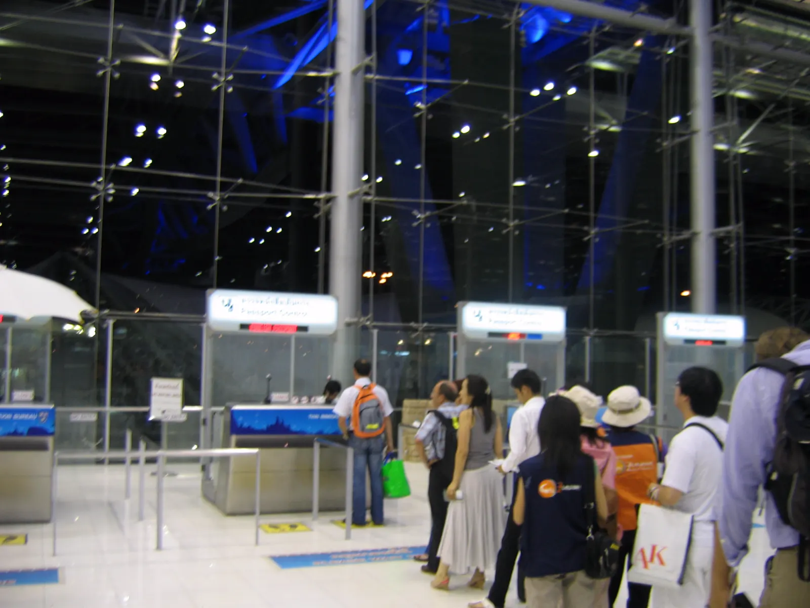 Travellers queueing at Bangkok airport immigration