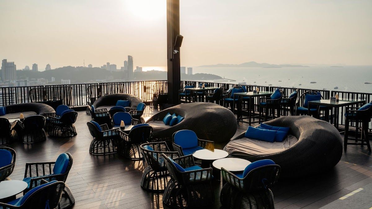 Rooftop dining terrace at dusk overlooking Pattaya Bay at the Hilton Pattaya